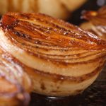 Grilled onions sliced in half